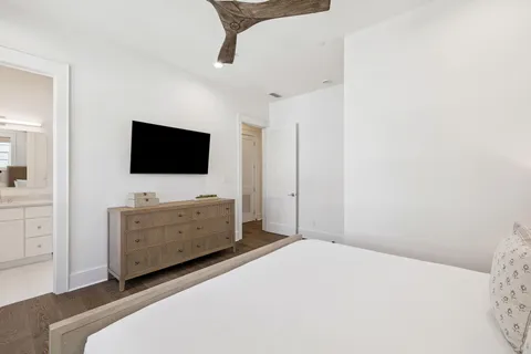 a kitchen with white cabinets and sink