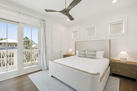 a bedroom with a large bed and a large window