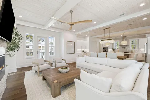 a kitchen with a table a sink cabinets and wooden floor