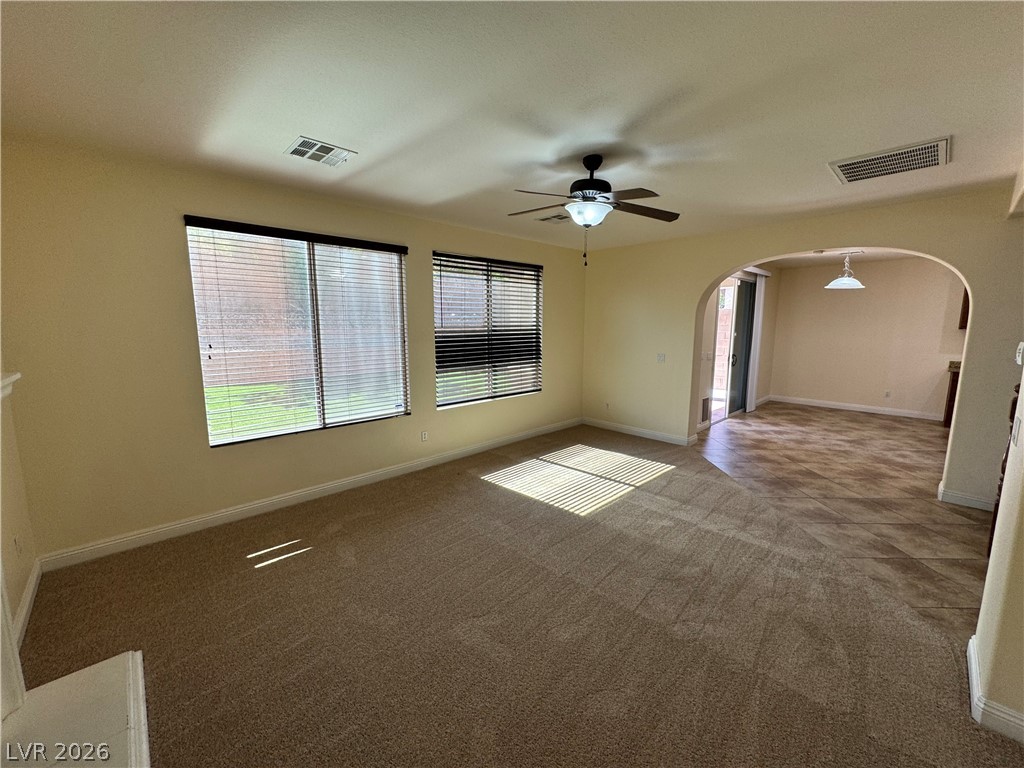 1333 Jamesbury Road Las Vegas, NV 89135 - Photo 14 of 43 A versatile living space with plush carpeting, illuminated by natural light through ample windows.