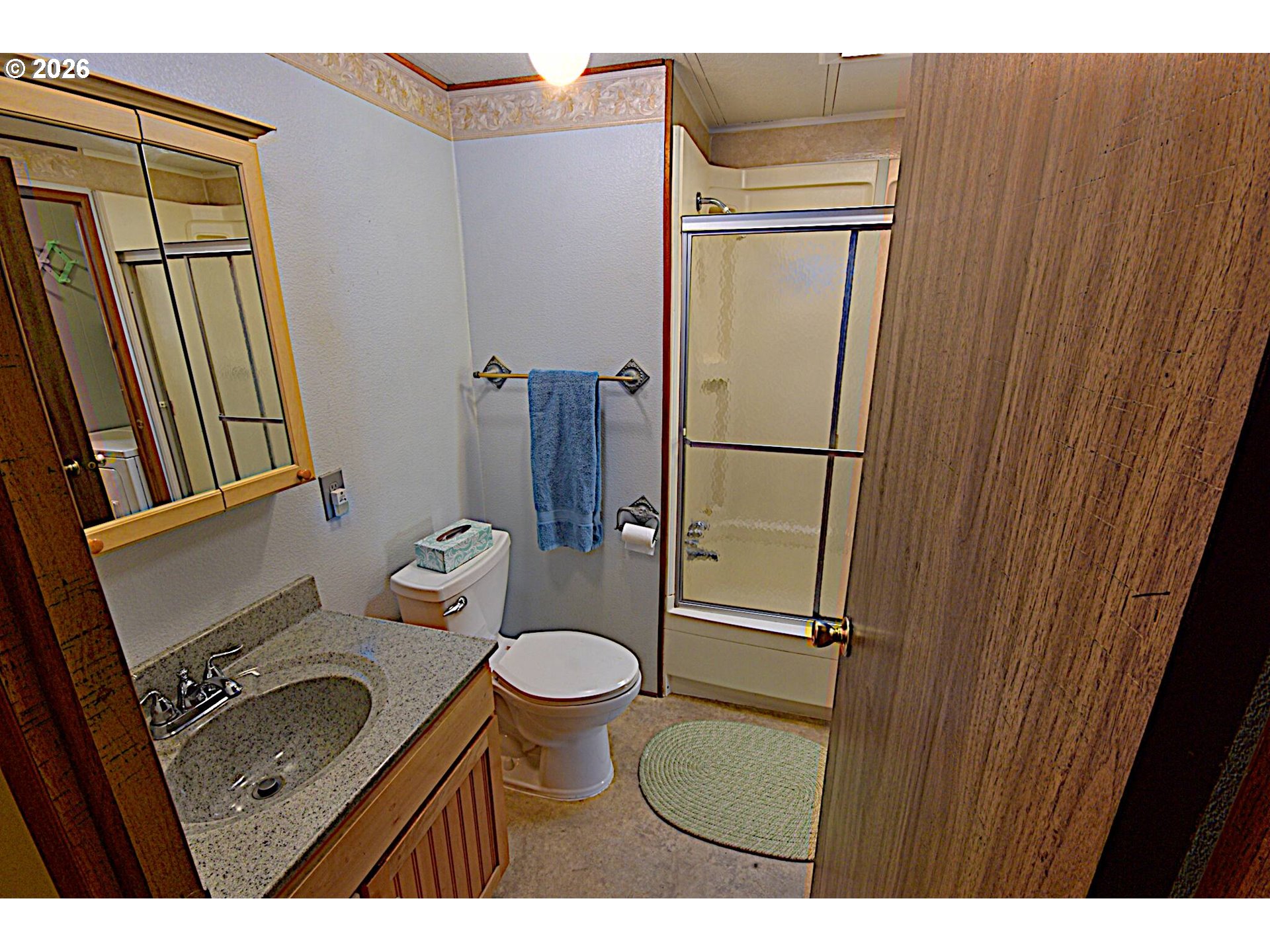 569 South 51st Place Springfield, OR 97478 - Photo 20 of 40 a bathroom with a granite countertop sink toilet and shower