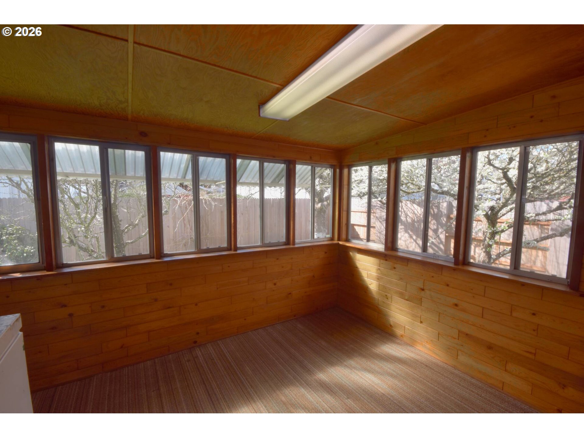 569 South 51st Place Springfield, OR 97478 - Photo 23 of 40 a view of an empty room with wooden floor and a floor to ceiling window