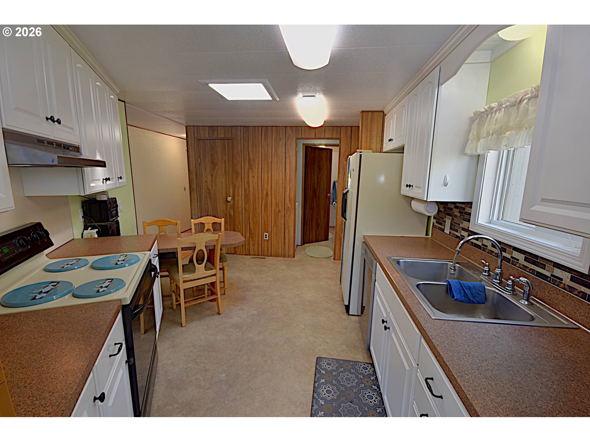 569 South 51st Place Springfield, OR 97478 - Photo 3 of 40 a kitchen with stainless steel appliances granite countertop a sink stove and refrigerator