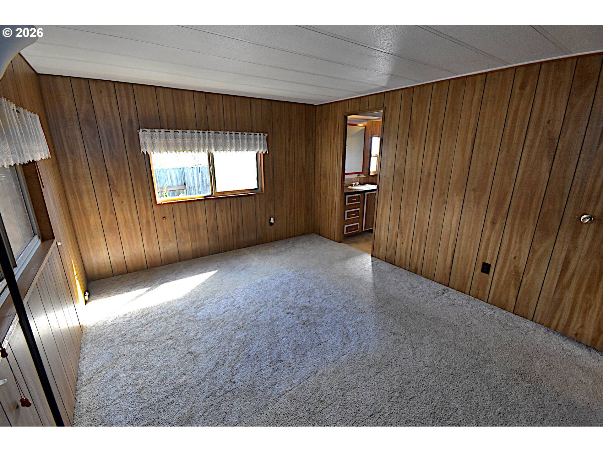 569 South 51st Place Springfield, OR 97478 - Photo 10 of 40 a view of an empty room with wooden floor and a window