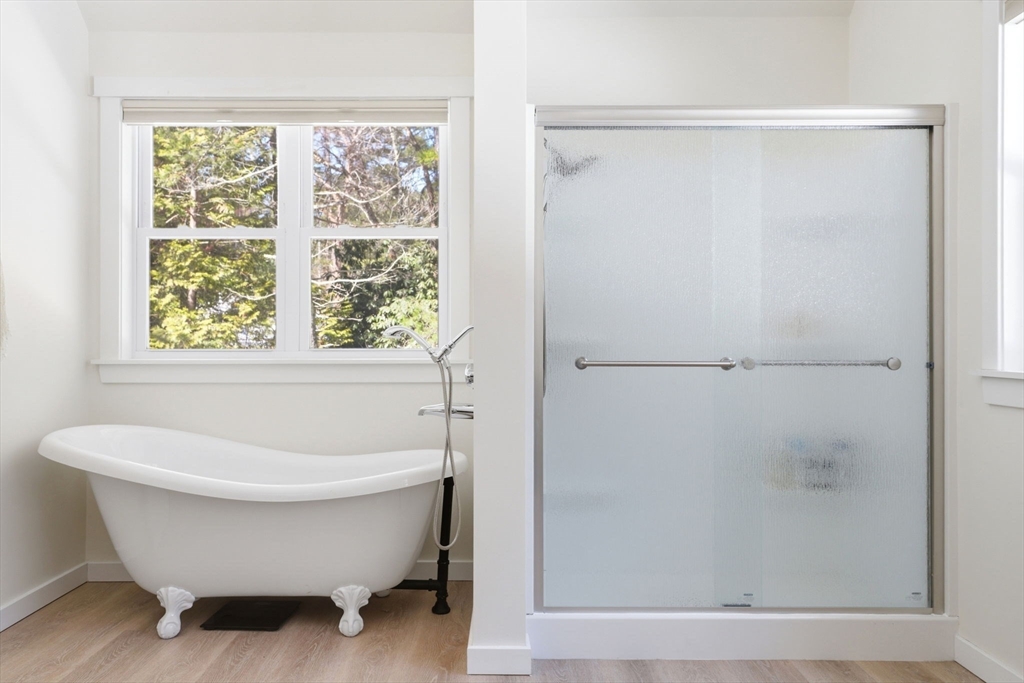 7 Crane Landing Road Wareham, MA 02571 - Photo 14 of 40 a bathroom with a bathtub and a window