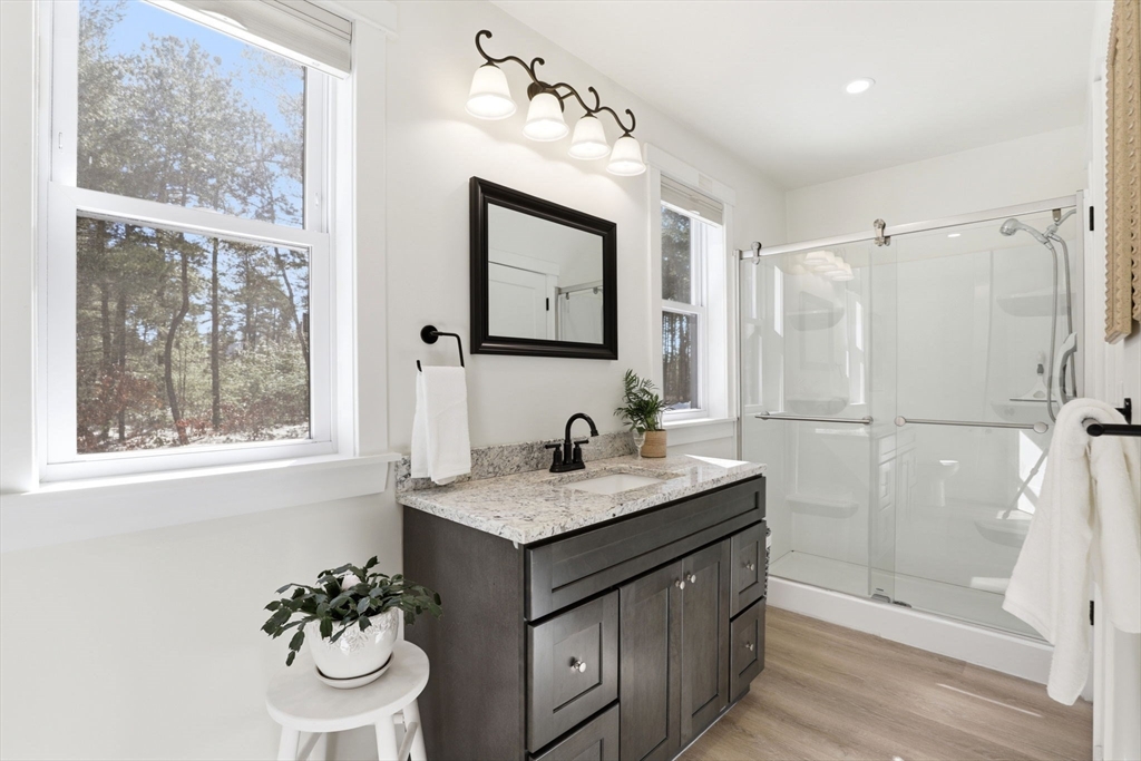 7 Crane Landing Road Wareham, MA 02571 - Photo 16 of 40 a bathroom with a granite countertop sink toilet and mirror