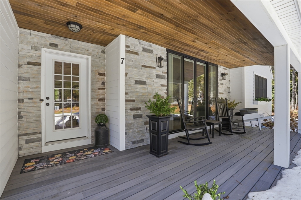 7 Crane Landing Road Wareham, MA 02571 - Photo 2 of 40 a view of a patio with table and chairs and wooden floor