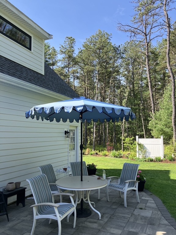 7 Crane Landing Road Wareham, MA 02571 - Photo 26 of 40 a chair and a table in a backyard