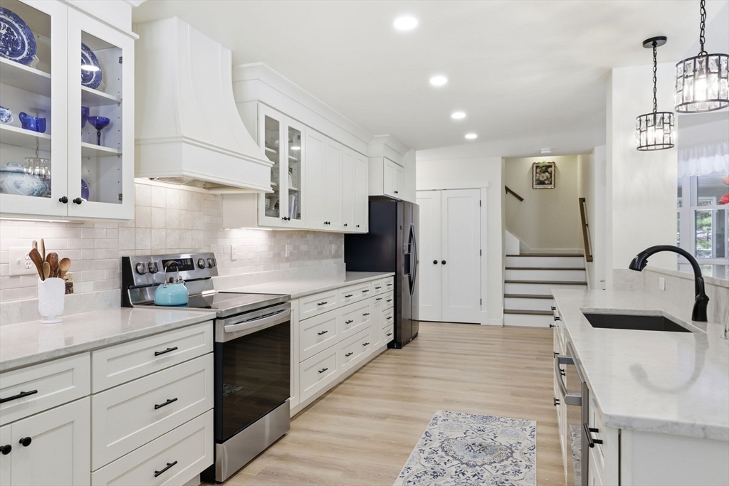 7 Crane Landing Road Wareham, MA 02571 - Photo 3 of 40 a kitchen with stainless steel appliances kitchen island granite countertop a refrigerator and a stove top oven