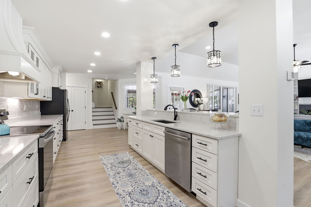 7 Crane Landing Road Wareham, MA 02571 - Photo 4 of 40 a kitchen with stainless steel appliances a sink stove and cabinets