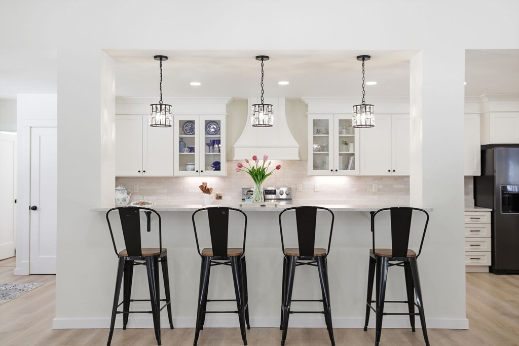 7 Crane Landing Road Wareham, MA 02571 - Photo 6 of 40 a view of a dining room with furniture wooden floor and chandelier