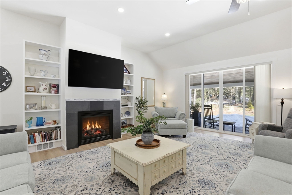 7 Crane Landing Road Wareham, MA 02571 - Photo 8 of 40 a living room with furniture a flat screen tv and a fireplace