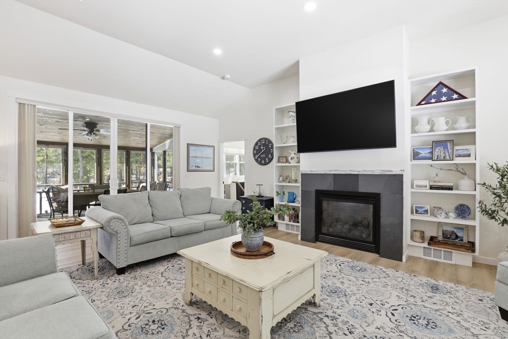 7 Crane Landing Road Wareham, MA 02571 - Photo 9 of 40 a living room with furniture a flat screen tv and a fireplace