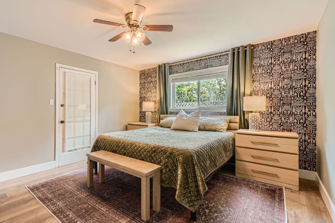 13223 Broadmeade Avenue Austin, TX 78729 - Photo 2 of 39 a bedroom with a bed and a chandelier