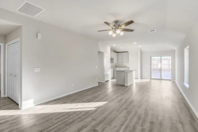 a view of a kitchen with wooden floor and a kitchen