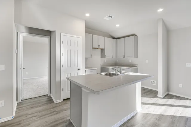 a kitchen with a sink and a refrigerator