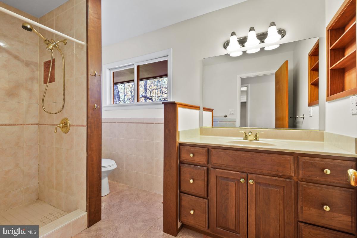 2606 Deerdell Lane Reston, VA 20191 - Photo 31 of 49 a bathroom with a double vanity sink mirror and shower