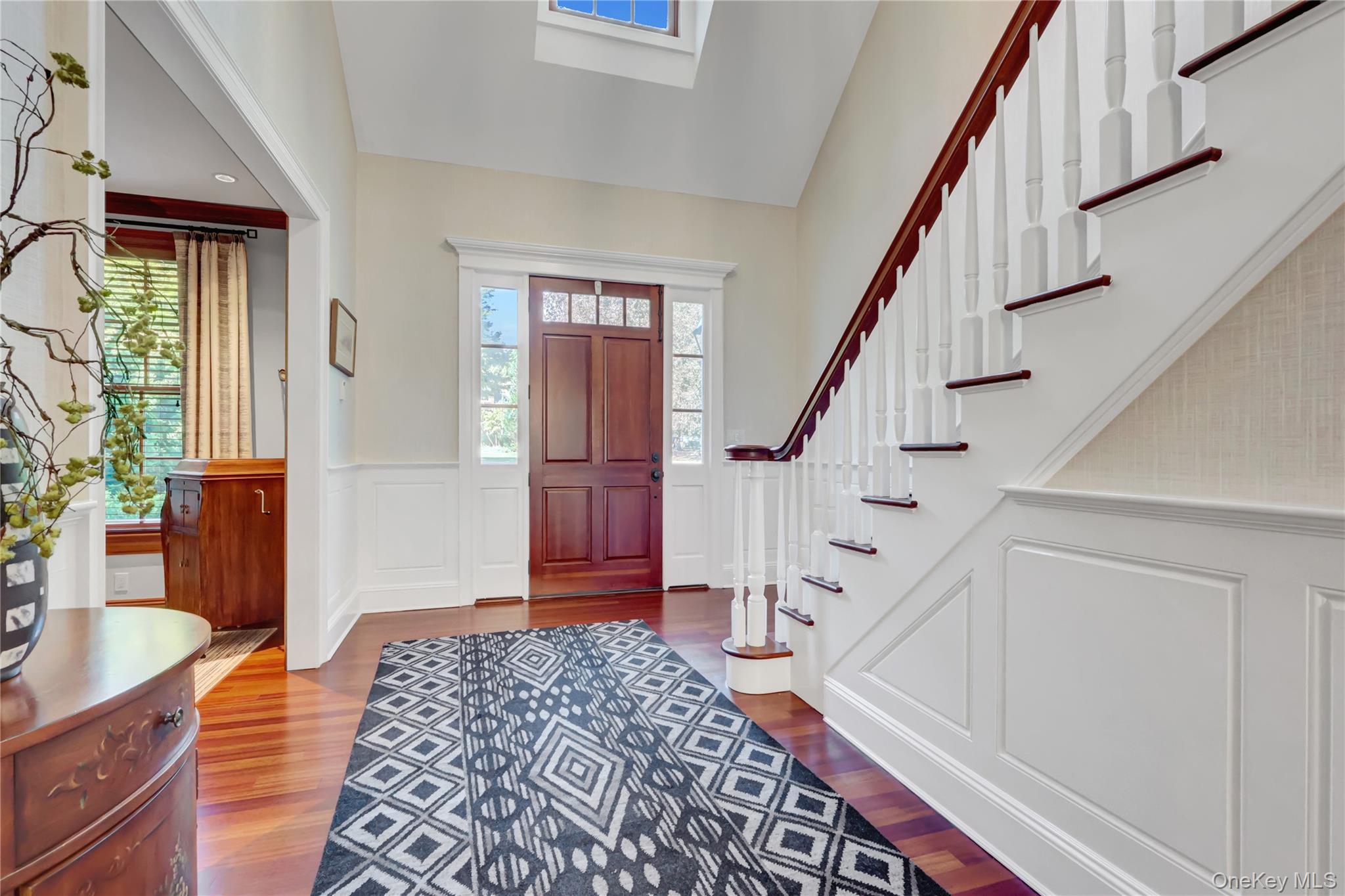 63 Dyke Road Setauket, NY 11733 - Photo 5 of 49 Foyer featuring a wainscoted wall, a decorative wall, and wood finished floors