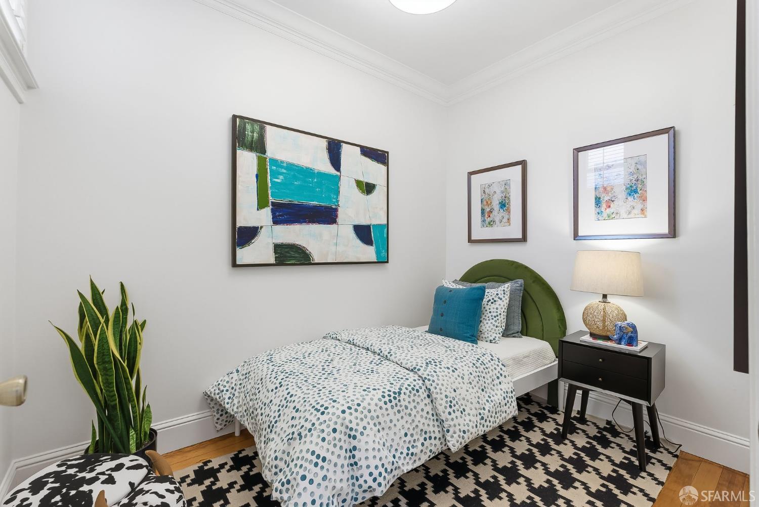 717 Page Street San Francisco, CA 94117 - Photo 19 of 39 a bedroom with a bed and wooden floor