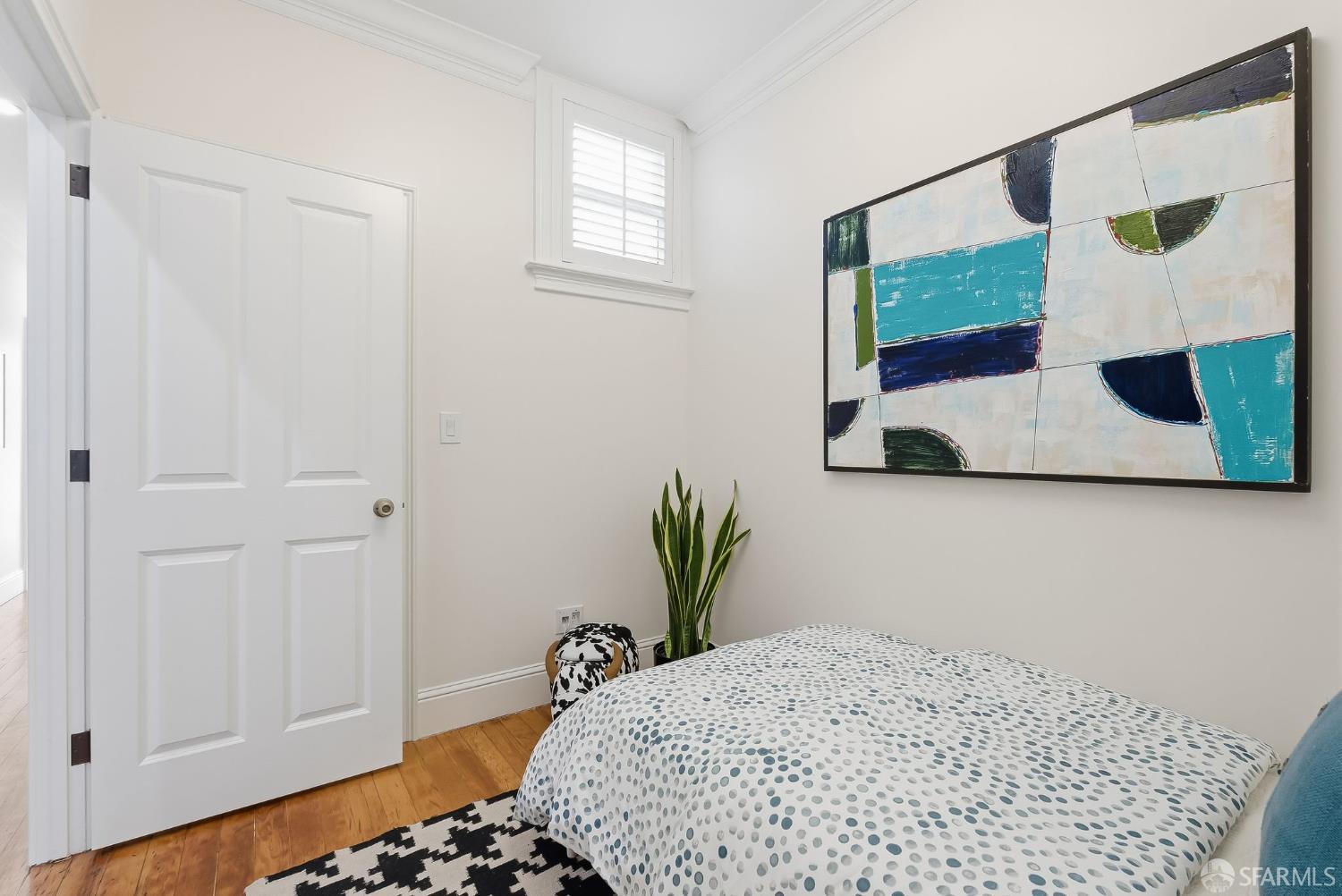 717 Page Street San Francisco, CA 94117 - Photo 20 of 39 a bedroom with a bed and wooden floor