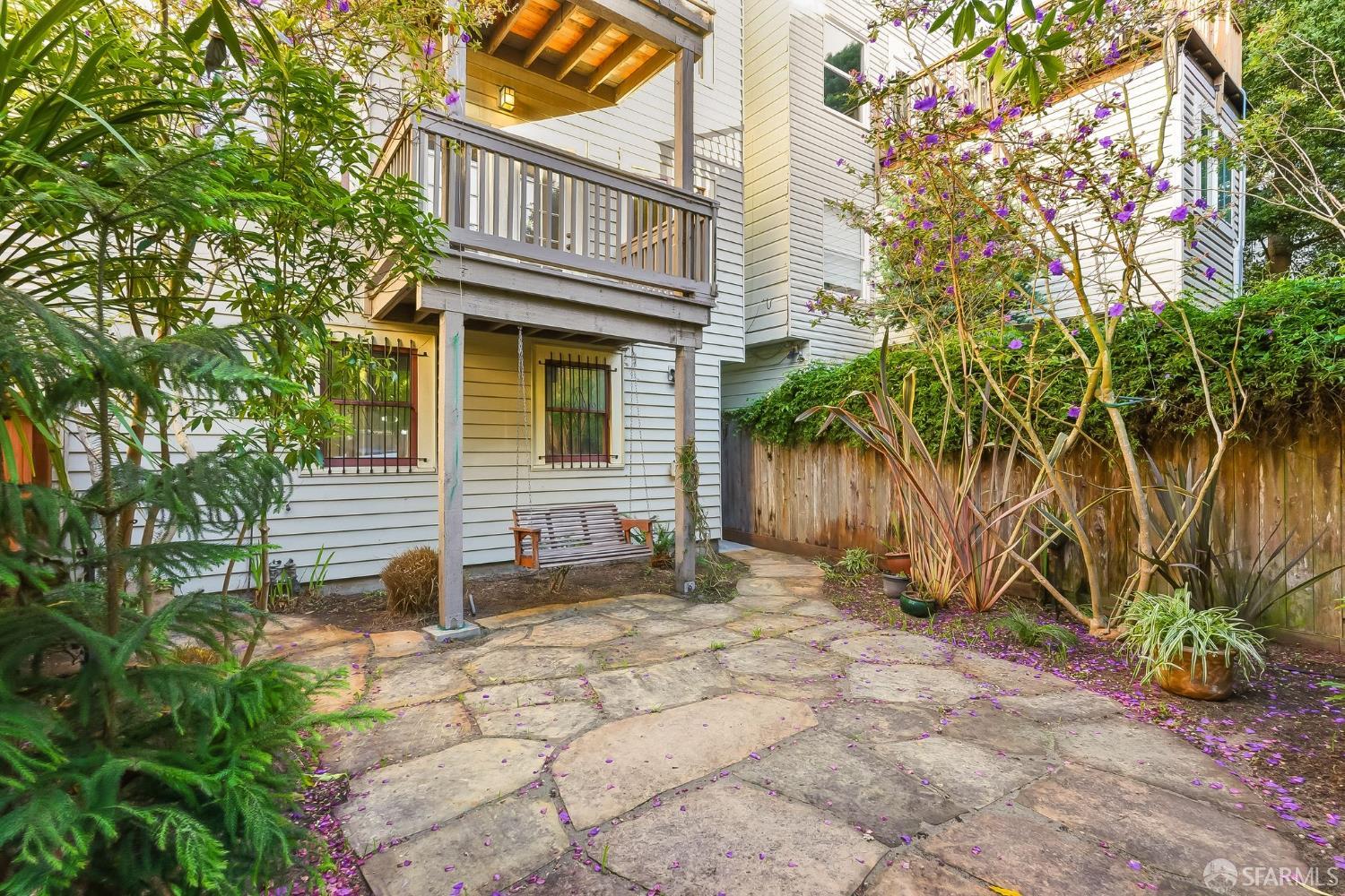 717 Page Street San Francisco, CA 94117 - Photo 27 of 39 a backyard of a house with barbeque oven table and chairs