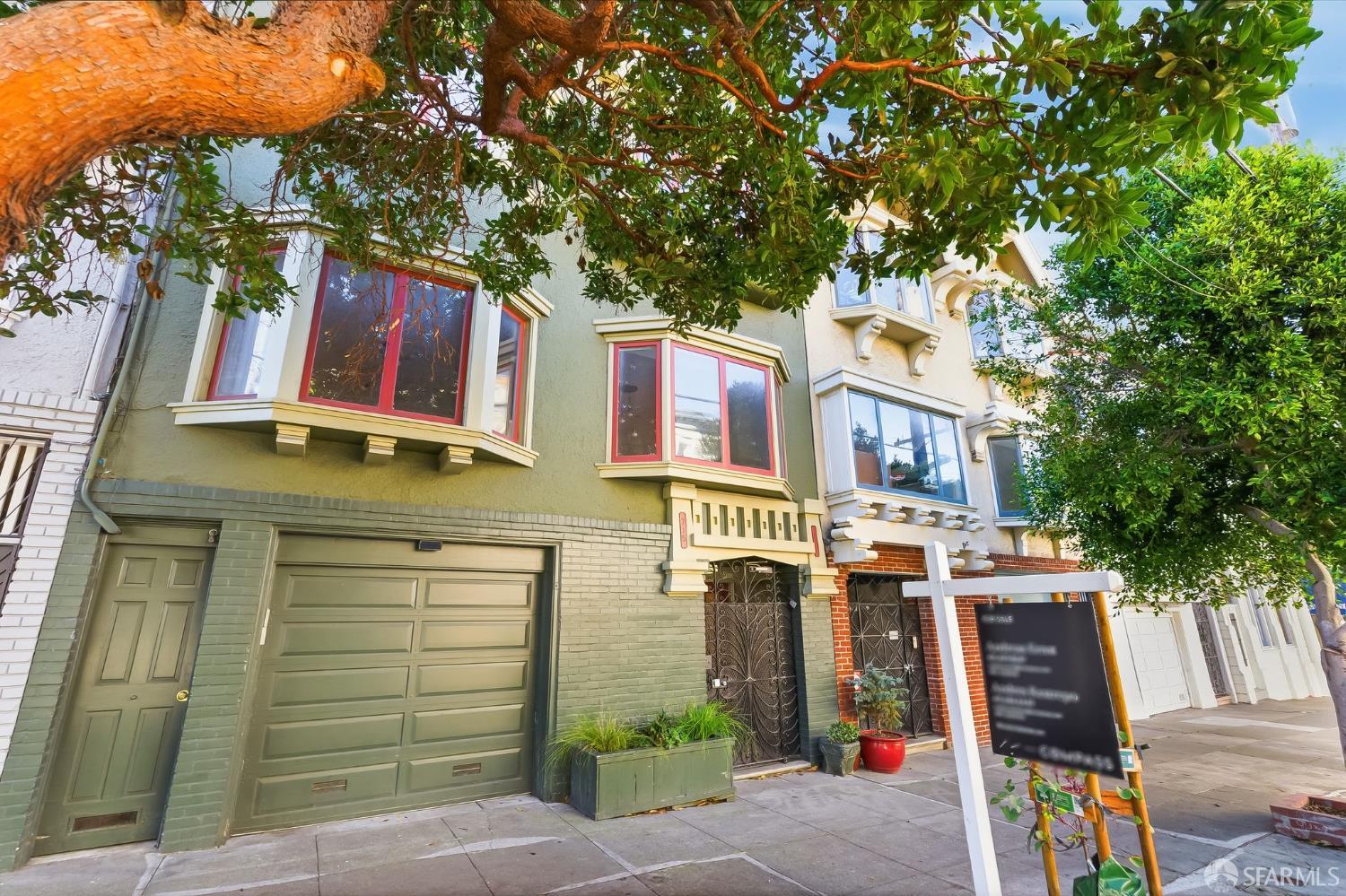 717 Page Street San Francisco, CA 94117 - Photo 30 of 39 a front view of a building with large trees