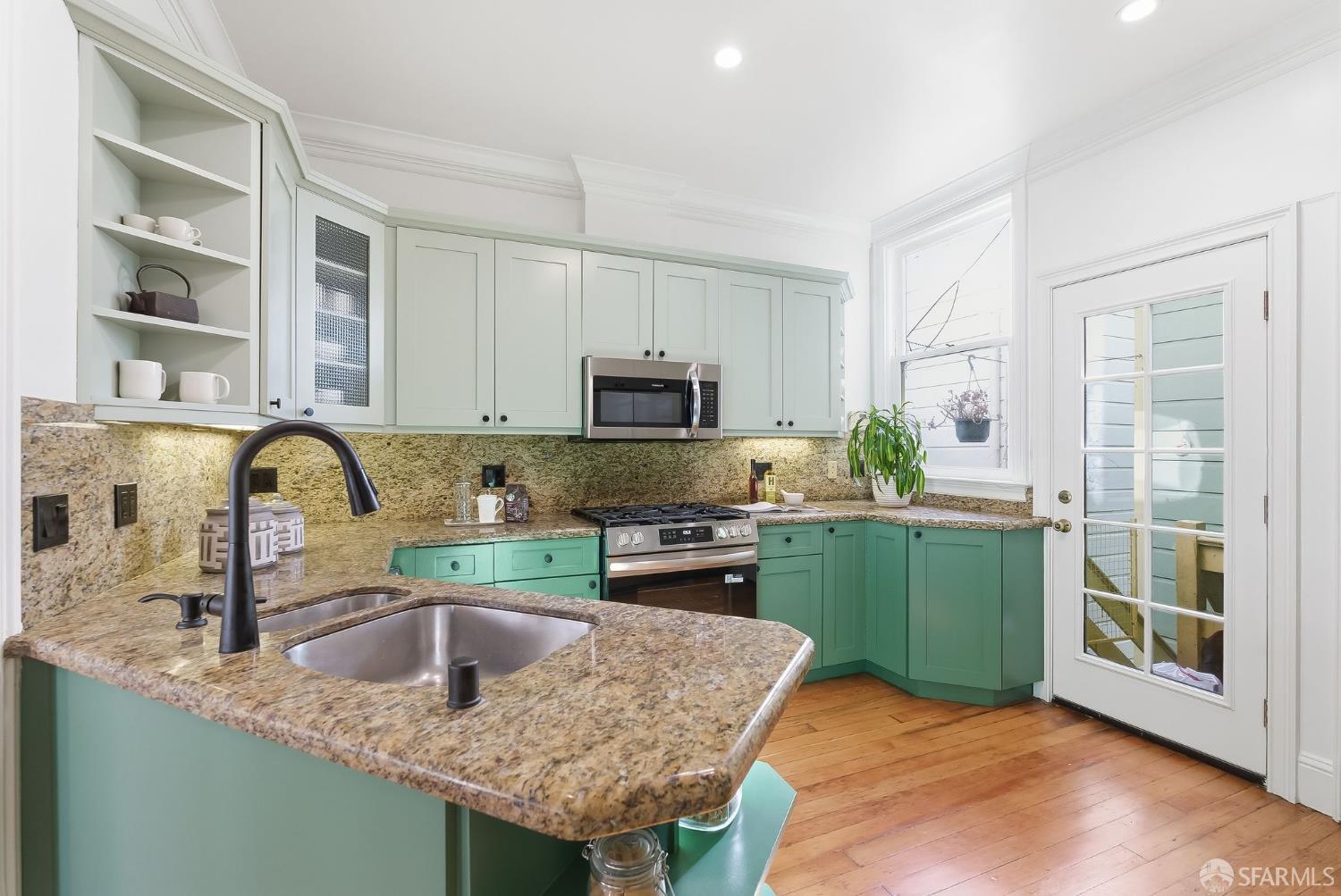 717 Page Street San Francisco, CA 94117 - Photo 10 of 39 a kitchen with granite countertop a sink a stove and cabinets