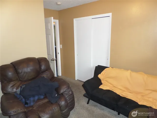 a living room with furniture and a chair