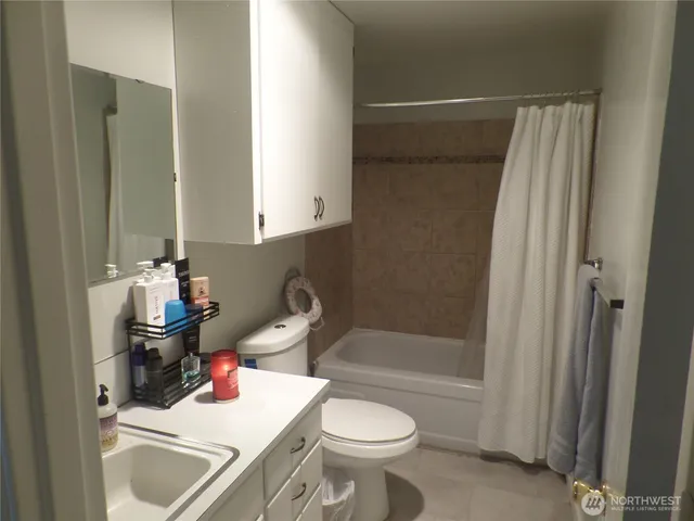 a living room with furniture and a lamp