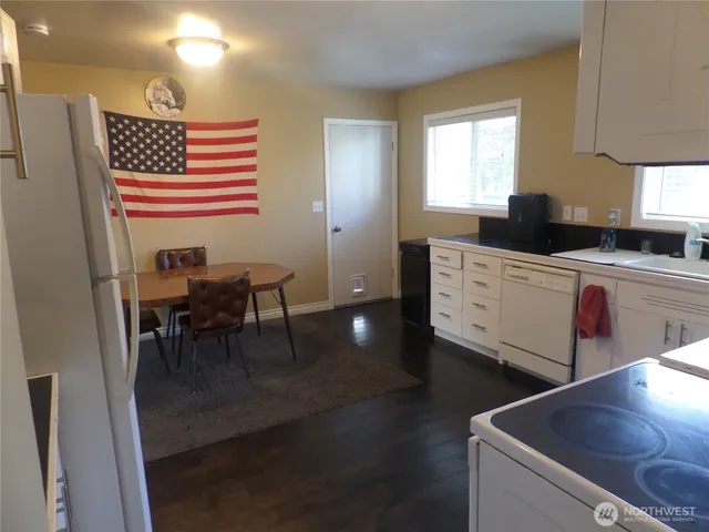 a kitchen with stainless steel appliances granite countertop a sink a stove and a refrigerator