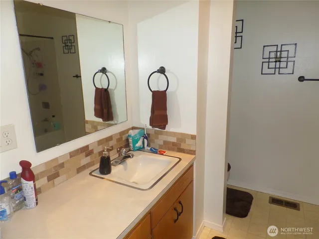 a bathroom with a sink and a mirror