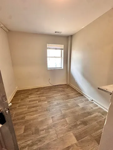 an empty room with a empty space and windows