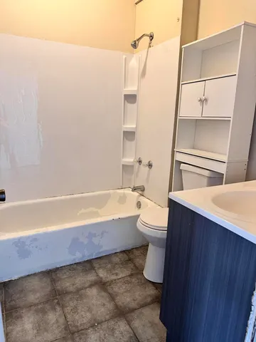 a bathroom with a bathtub sink and toilet
