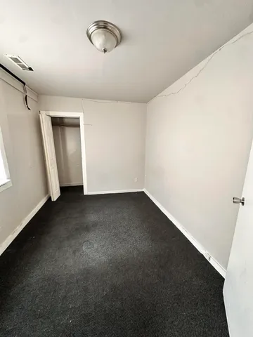 an empty room with a empty space and windows