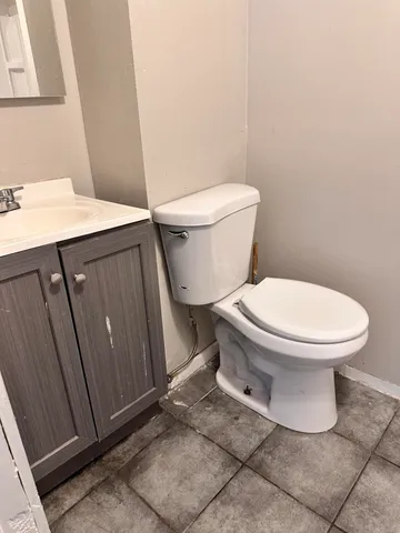 a white toilet sitting next to a bathroom sink