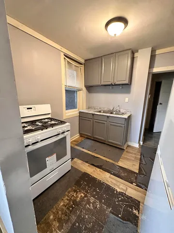 a kitchen with granite countertop a stove and a sink