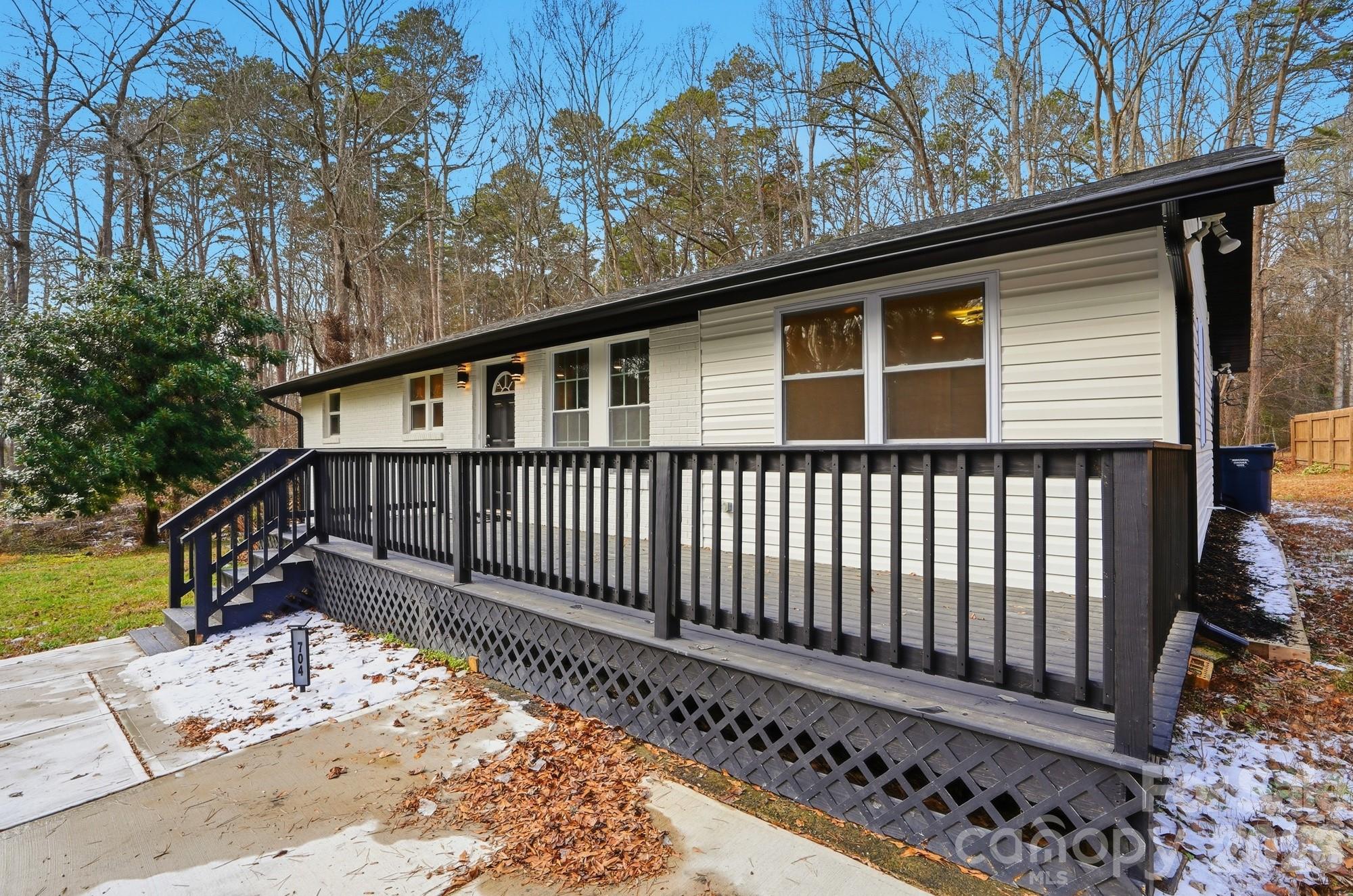 704 West Border Street Dallas, NC 28034 - Photo 13 of 48 a view of a house with a small yard and wooden fence
