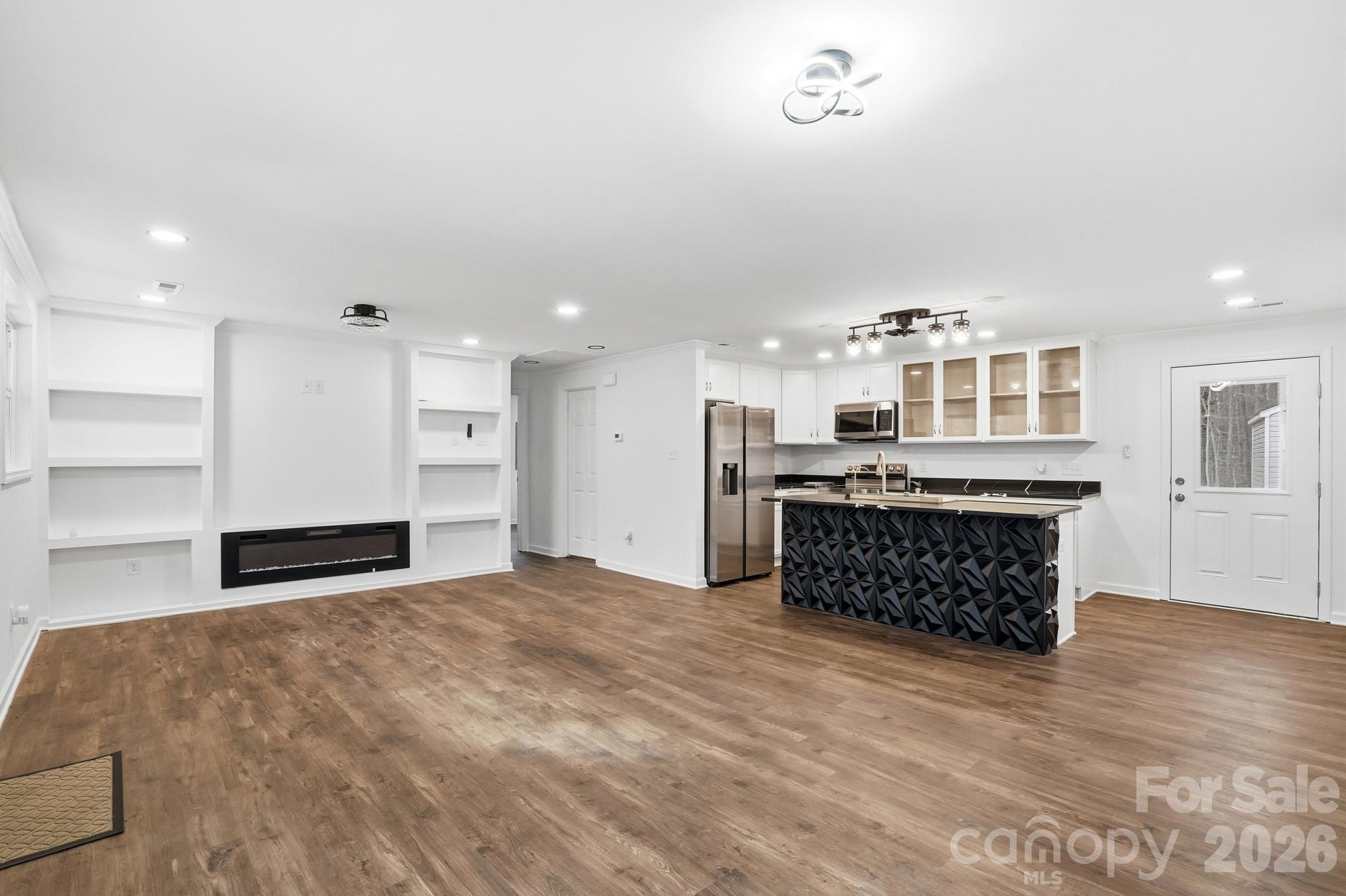 704 West Border Street Dallas, NC 28034 - Photo 17 of 48 a kitchen with stainless steel appliances a large counter top a stove and a refrigerator