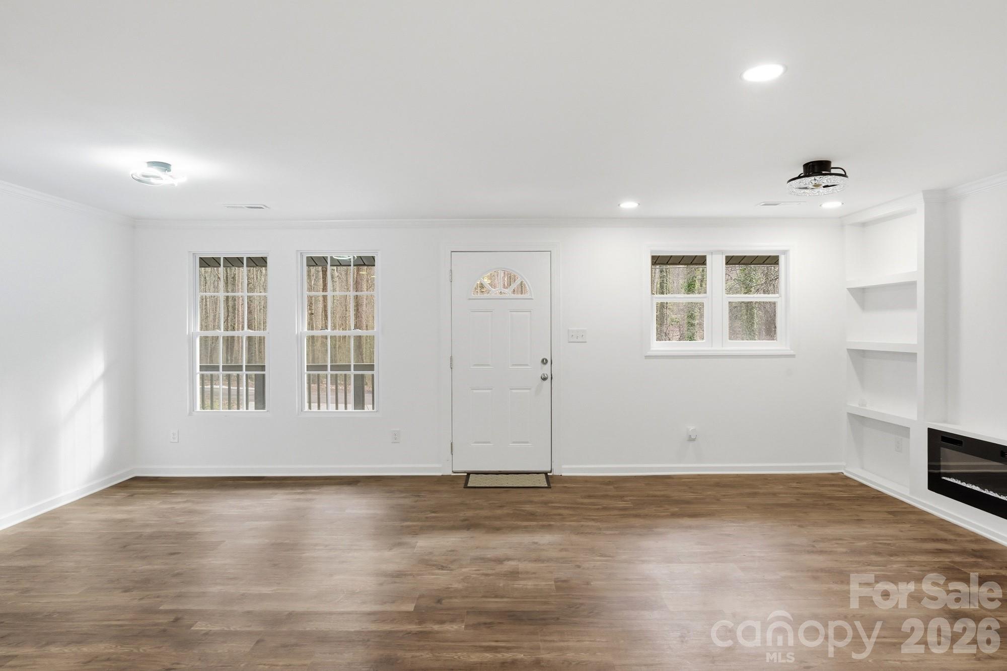 704 West Border Street Dallas, NC 28034 - Photo 20 of 48 an empty room with wooden floor and windows
