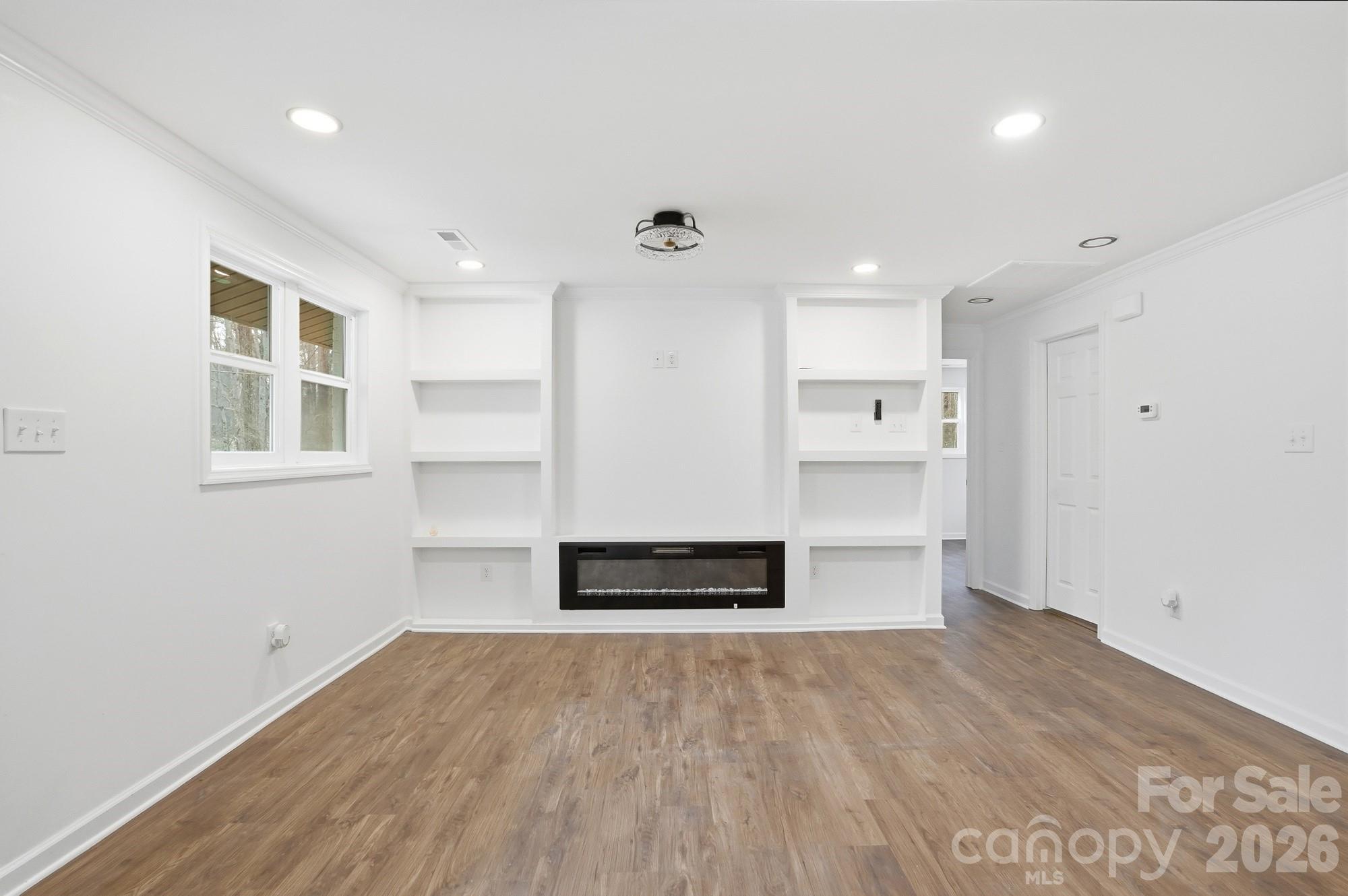 704 West Border Street Dallas, NC 28034 - Photo 23 of 48 a view of empty room with wooden floor and windows
