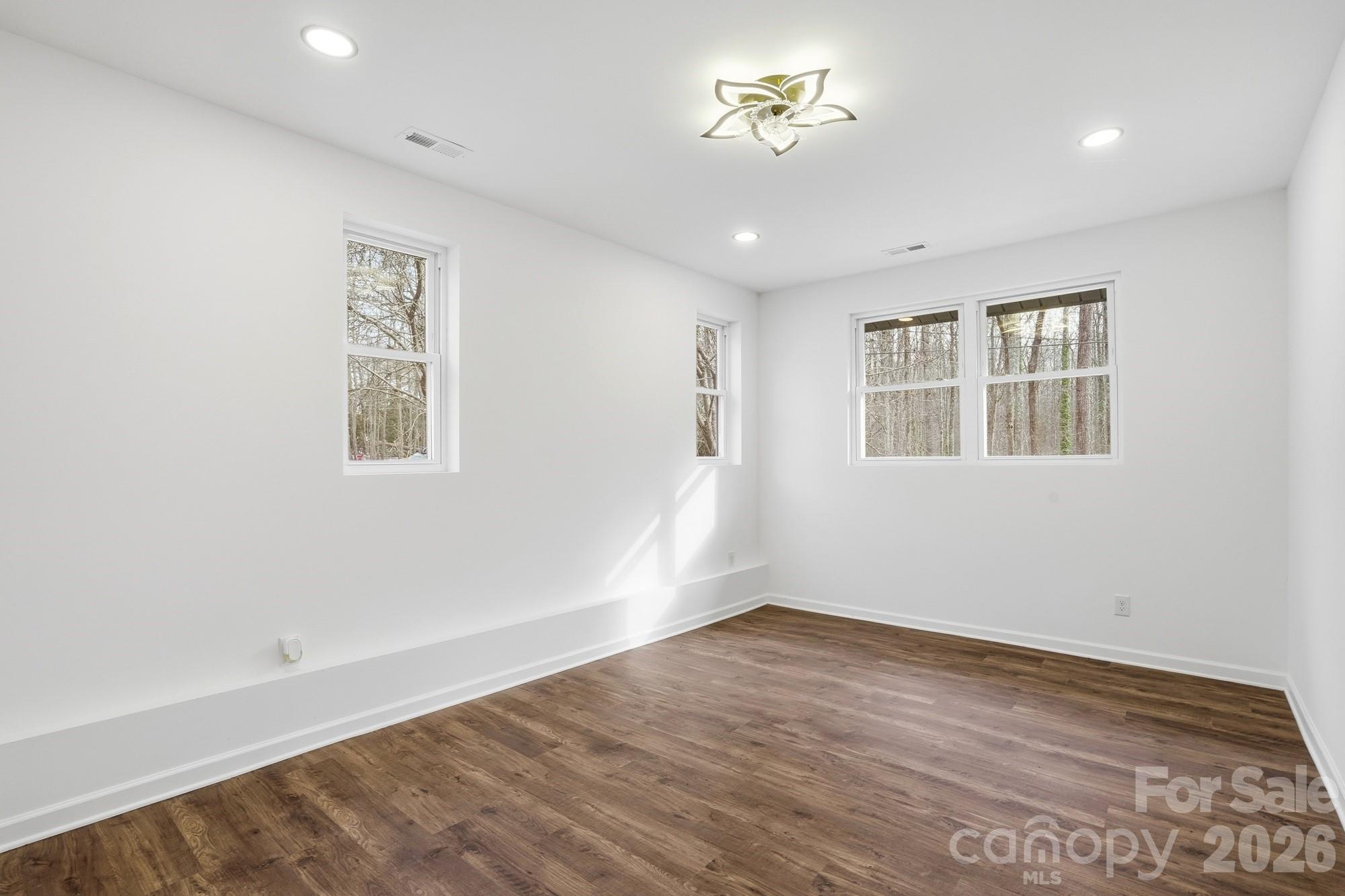 704 West Border Street Dallas, NC 28034 - Photo 28 of 48 a view of empty room with wooden floor and fan