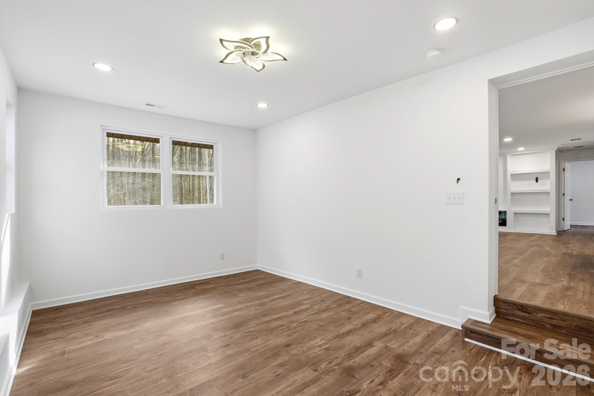 704 West Border Street Dallas, NC 28034 - Photo 31 of 48 a view of empty room with wooden floor and fan