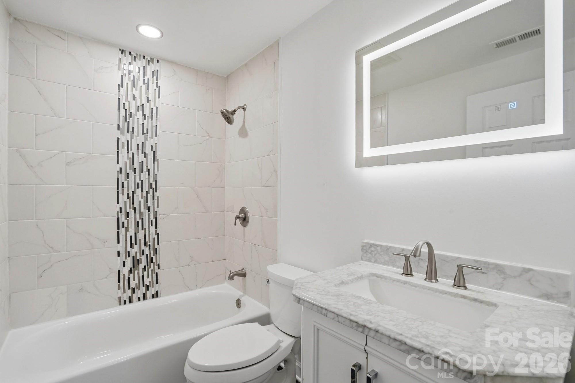704 West Border Street Dallas, NC 28034 - Photo 37 of 48 a bathroom with a granite countertop sink toilet and shower