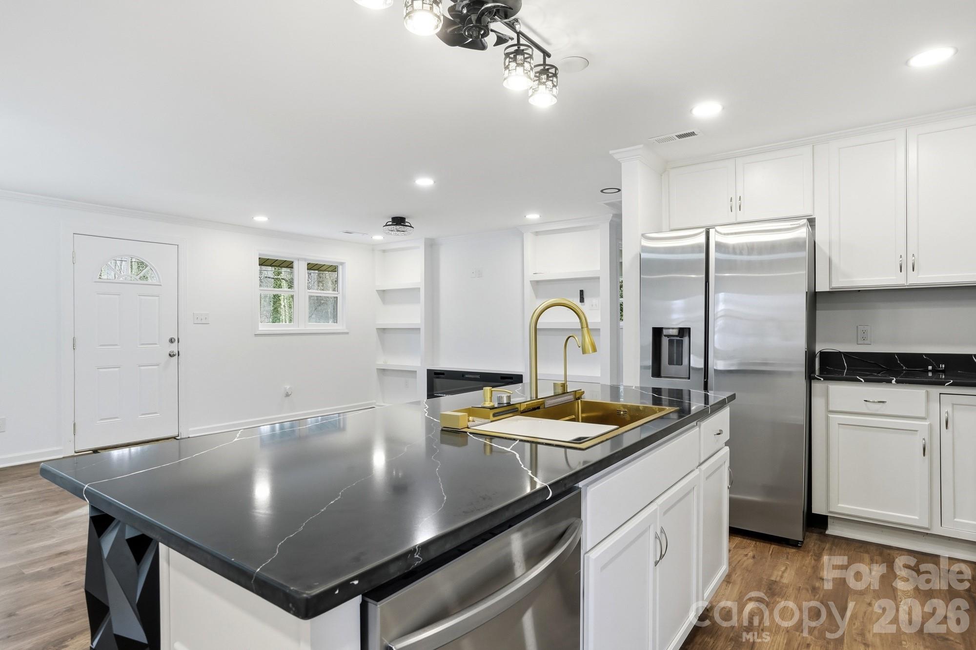 704 West Border Street Dallas, NC 28034 - Photo 6 of 48 a kitchen with stainless steel appliances granite countertop a sink a stove and refrigerator