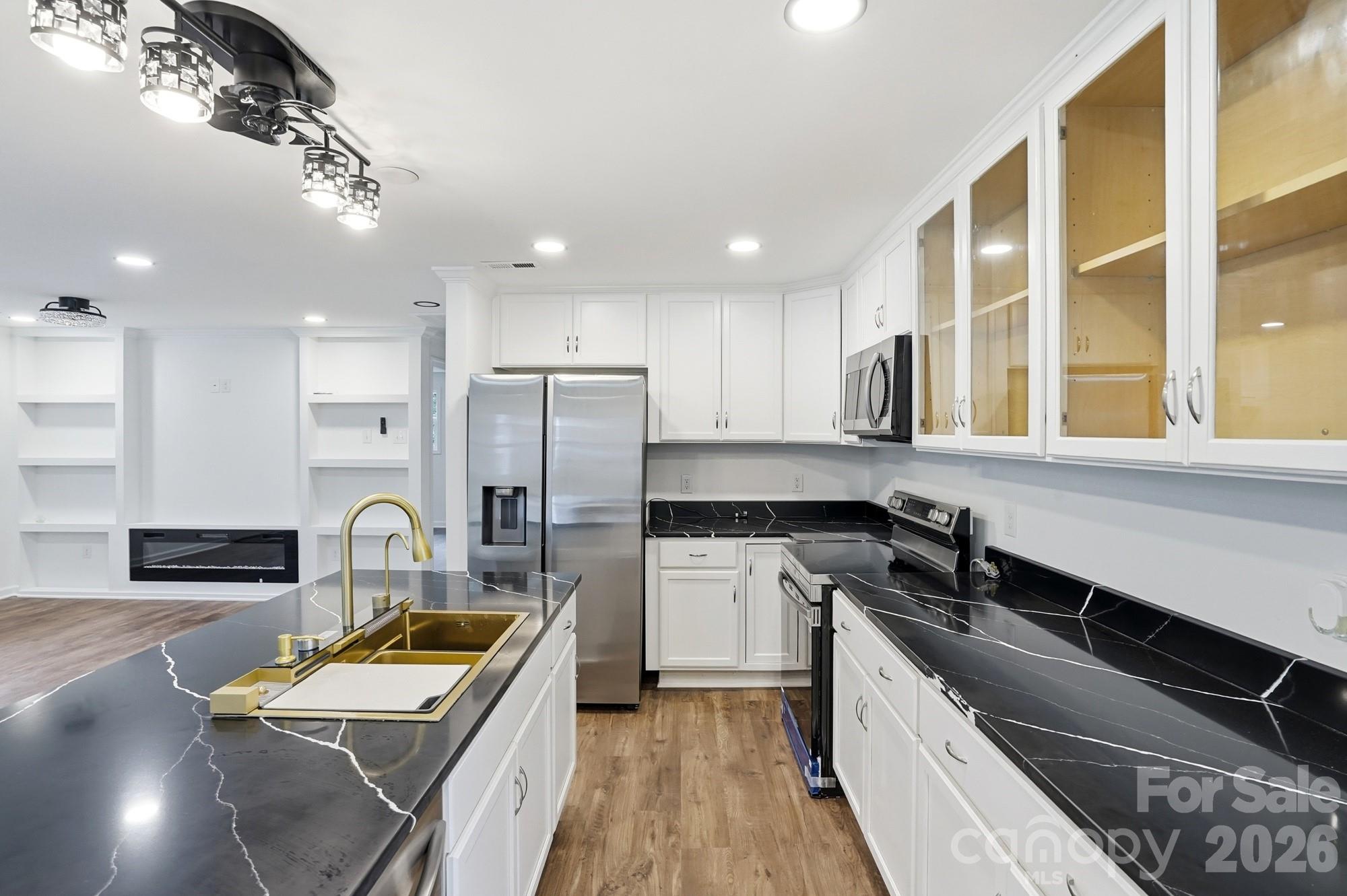 704 West Border Street Dallas, NC 28034 - Photo 7 of 48 a kitchen with stainless steel appliances granite countertop a sink a stove and a refrigerator