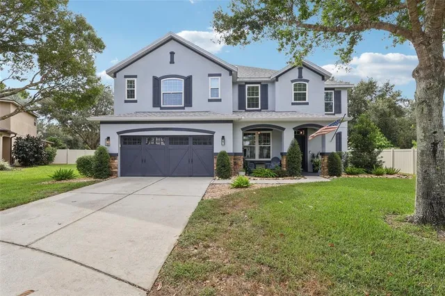 a front view of a house with a yard and garage