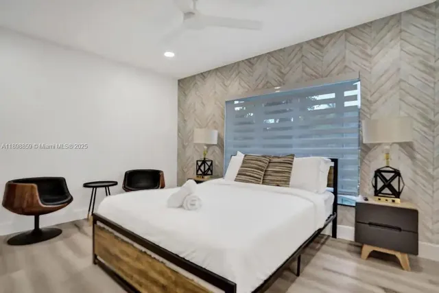 a bedroom with a bed and a lamp