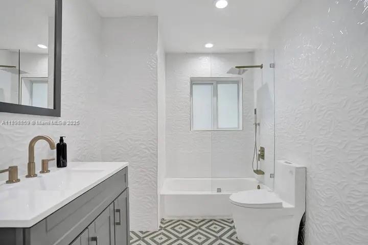 2100 Southwest 28th Way Fort Lauderdale, FL 33312 - Photo 23 of 40 a bathroom with a sink toilet a mirror and bathtub