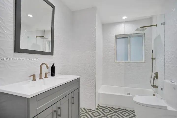 2100 Southwest 28th Way Fort Lauderdale, FL 33312 - Photo 24 of 40 a bathroom with a sink a toilet and shower