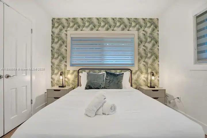 2100 Southwest 28th Way Fort Lauderdale, FL 33312 - Photo 30 of 40 a bedroom with a bed and a fireplace